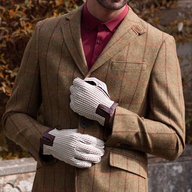 classic crochet men's driving gloves wearing a vintage tweed suit