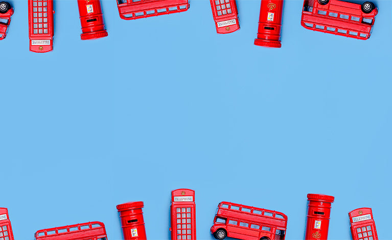 Red London phone booths and buses arranged in a pattern on a blue background