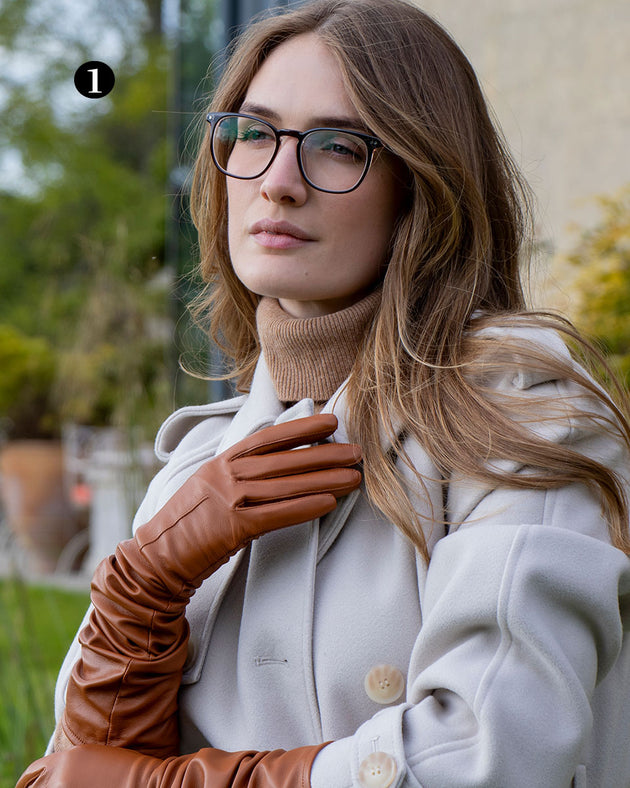 Woman wearing single point long above elbow lined leather gloves in cognac