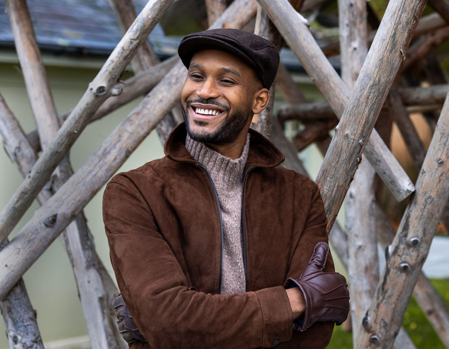 A man wearing a flat cap in brown outdoors