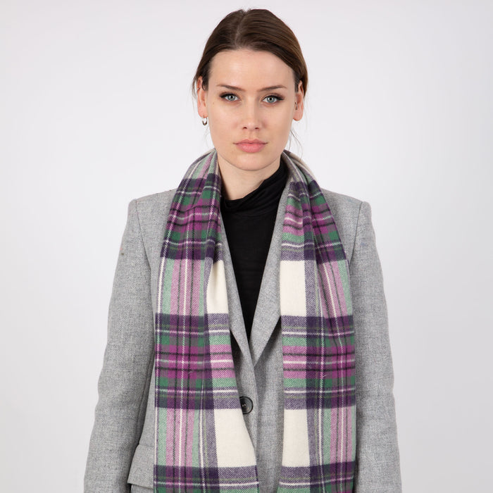 Woman wearing a Heritage plaid check cashmere scarf in ivory