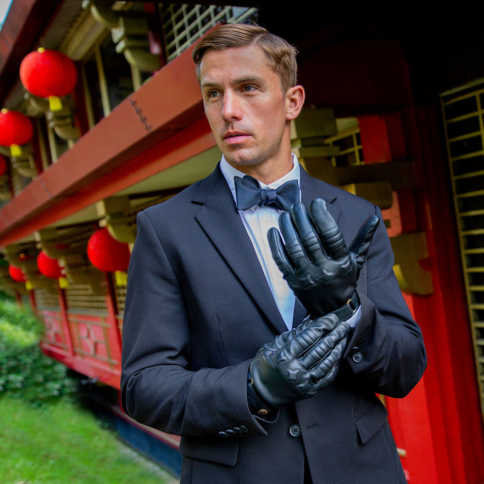 Man wearing black leather gloves and a tuxedo
