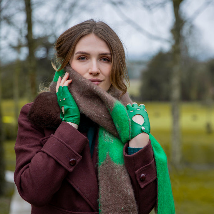 Woman wearing Fingerless Leather Driving Gloves in Emerald in a park