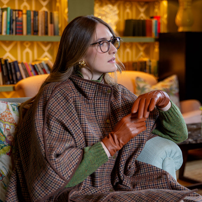 Woman wearing cashmere-lined leather gloves in cognac 