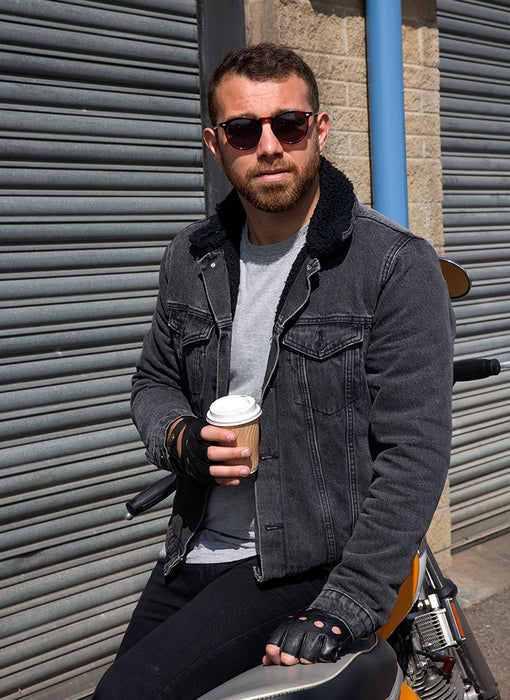 Man wearing Men's Fingerless Leather Driving Gloves in Black