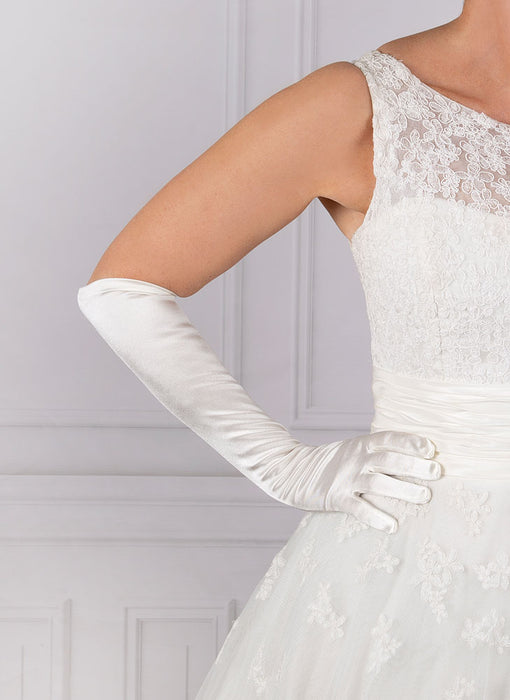 Woman wearing elbow length satin gloves in white