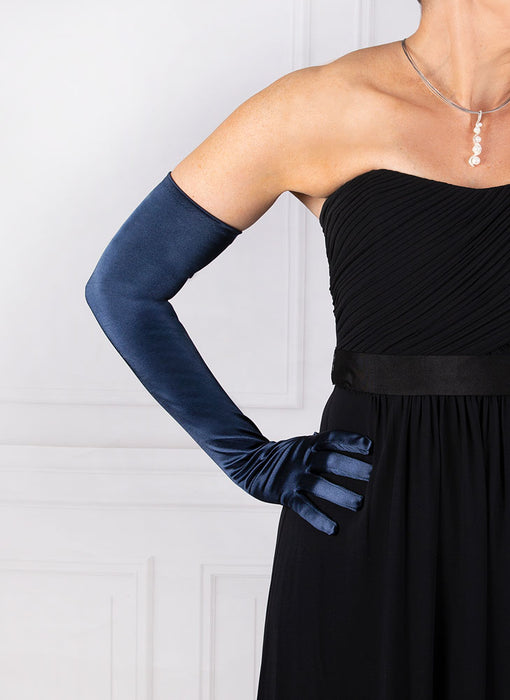 Woman wearing navy blue opera satin gloves with an evening dress