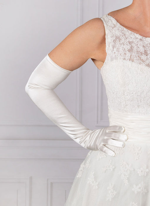 Woman wearing white opera satin gloves with a wedding dress