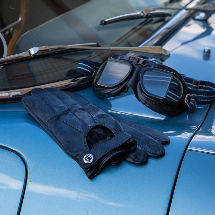 Men’s Three-Point Leather Driving Gloves with Wristwatch Cut-out in black on a car
